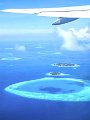 Aerial view of islands with airplane wing, Maldives